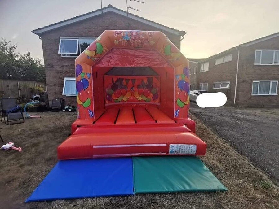 Red Party Time bouncy castle