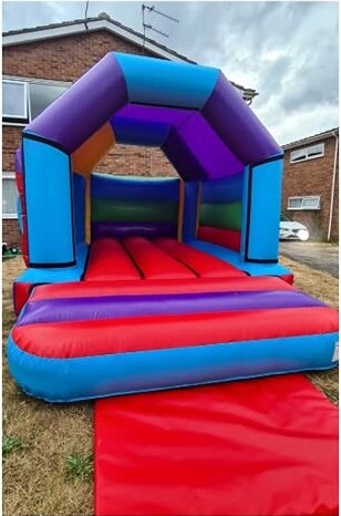 Rainbow multi-colour open-front bouncy castle